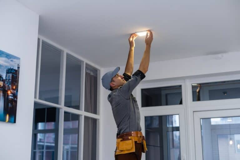 Electrician using ServiceBridge mobile app for field service management and job tracking