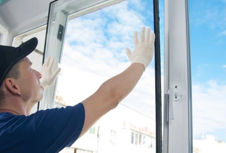 Glass installation technician using ServiceBridge mobile app for job scheduling and work order management