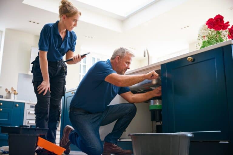 Plumbers using ServiceBridge tablet app for field service job management and invoicing